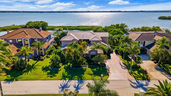 an aerial view of residential houses with outdoor space and river