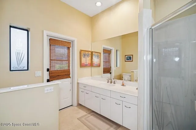 a bathroom with a double vanity sink mirror and double