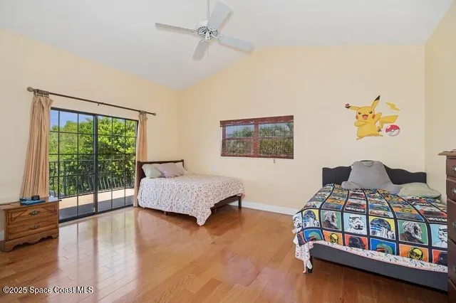 a bedroom with two beds and a large window