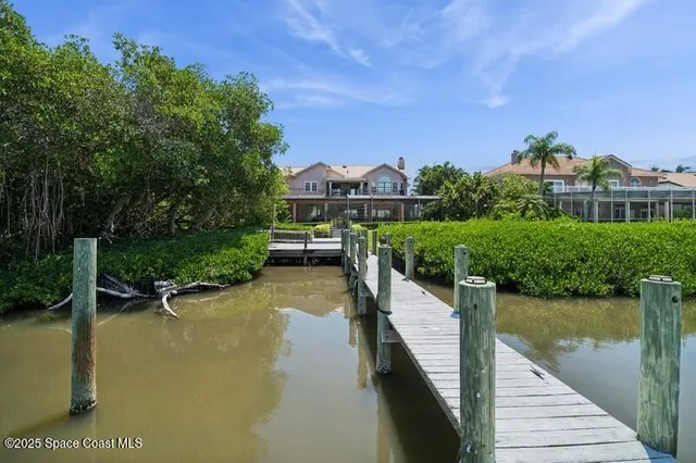 a view of a lake with a house in the background