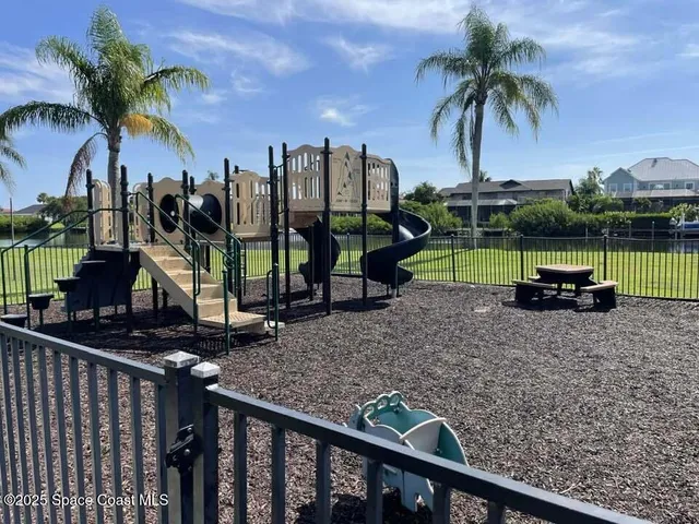 a view of a dining room with furniture water view and large windows