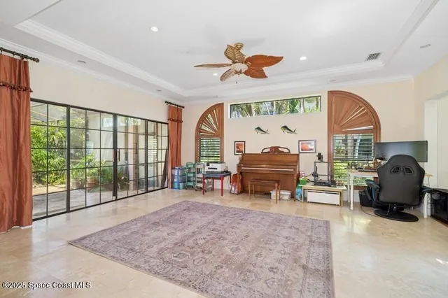 a living room with furniture a fireplace and a large window