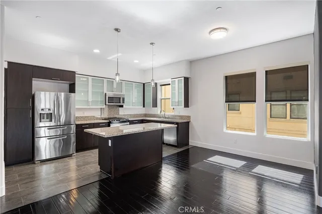 a kitchen with stainless steel appliances granite countertop a stove and a refrigerator