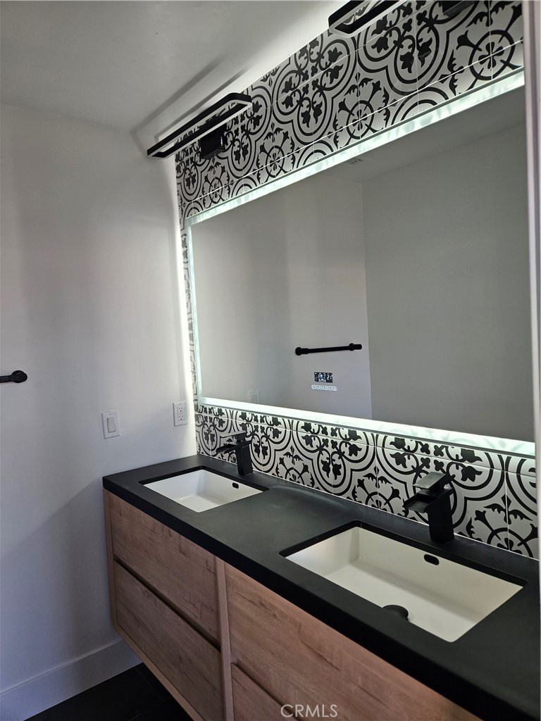190 West 3rd Street Santa Ana, CA 92701 - Photo 8 of 18 Upgraded bathroom with backlit mirror and modern vanity.