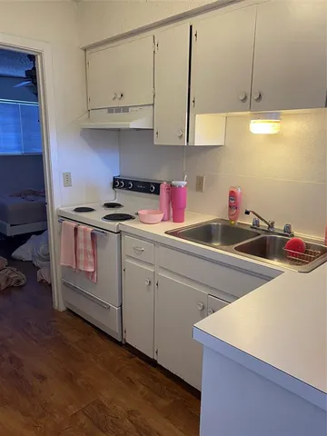 a kitchen with cabinets a sink and appliances