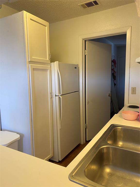 2808 Whitis Avenue, Unit C306 Austin, TX 78705 - Photo 3 of 4 a room with a refrigerator and wooden floor
