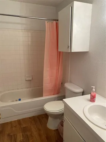 a bathroom with a sink a toilet and a bathtub