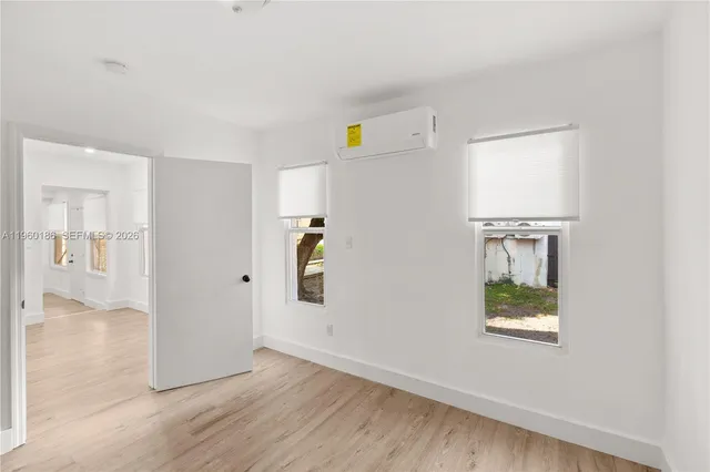 a view of an entryway with wooden floor and a window