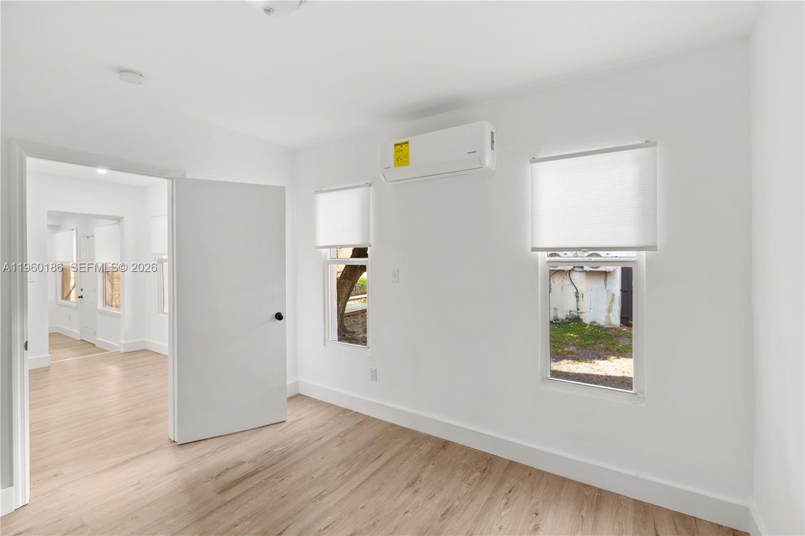 2508 Southwest 10th Street, Unit 2508 Miami, FL 33135 - Photo 12 of 26 a view of an entryway with wooden floor and a window