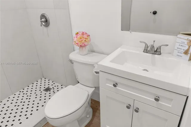 a bathroom with a sink a toilet and a shower