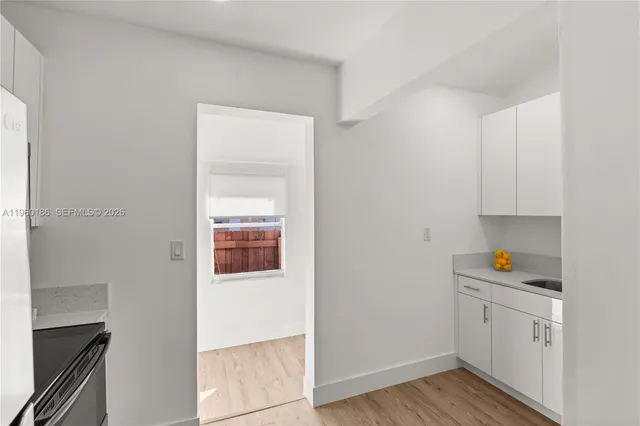 a view of cabinets and wooden floor
