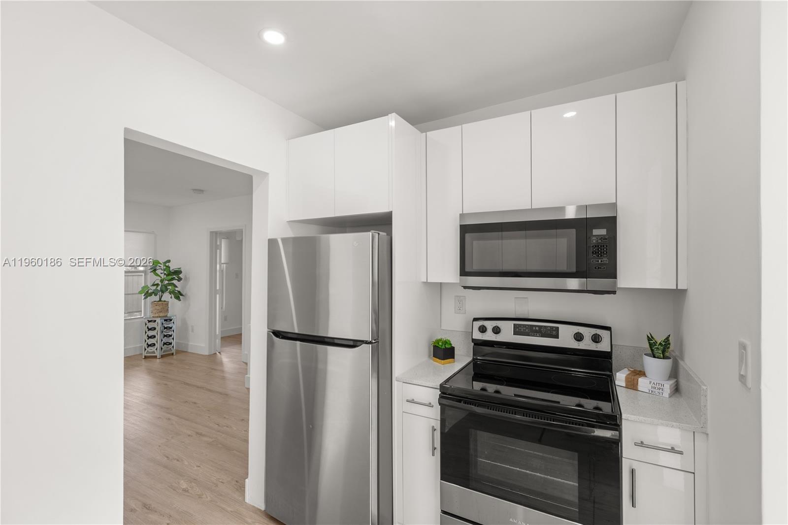 2508 Southwest 10th Street, Unit 2508 Miami, FL 33135 - Photo 22 of 26 a kitchen with a refrigerator and a stove top oven
