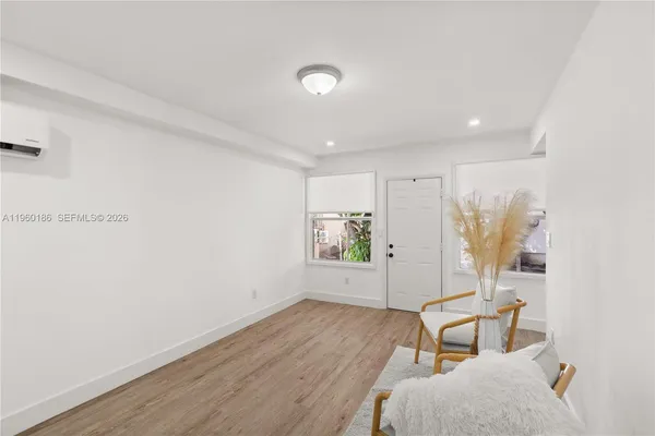 a view of room with window and wooden floor