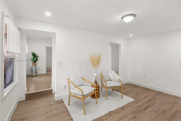 a living room with furniture and a dining area
