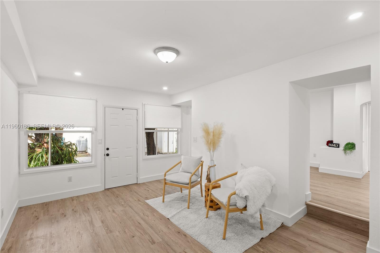 2508 Southwest 10th Street, Unit 2508 Miami, FL 33135 - Photo 7 of 26 a view of a room with wooden floor lounge chair and windows