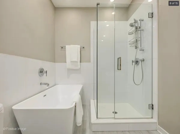 a bathroom with a shower a mirror and a shower