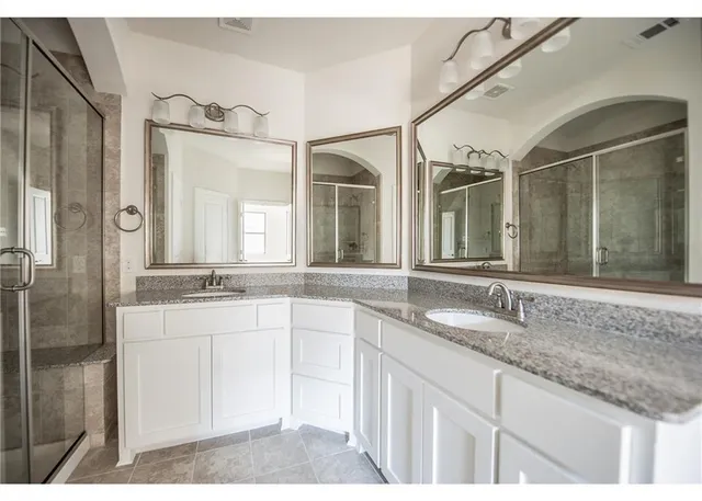 a bathroom with a granite countertop sink mirror and double