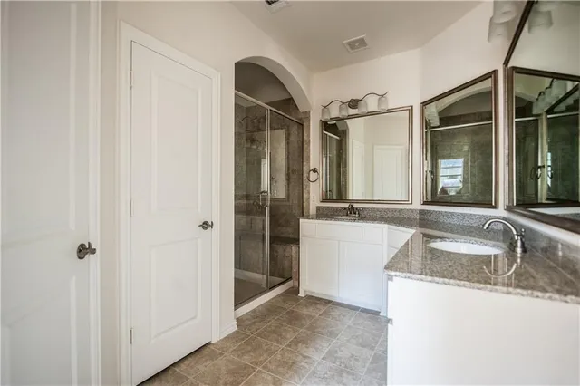 a kitchen with granite countertop a sink and a refrigerator