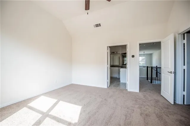 a view of empty room with wooden floor and a window