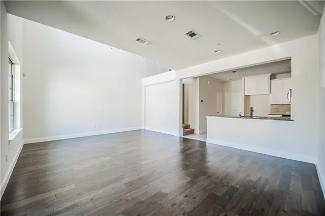 a view of a kitchen with wooden floor and a sink