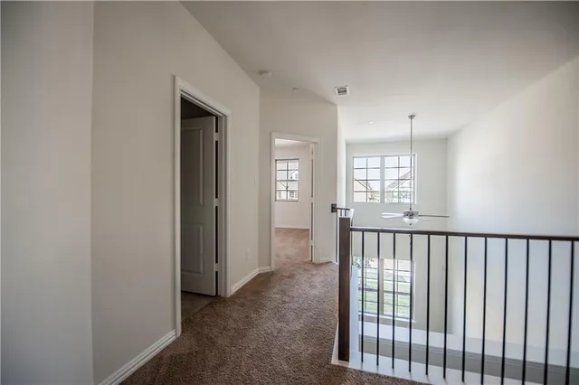 a view of hallway with windows