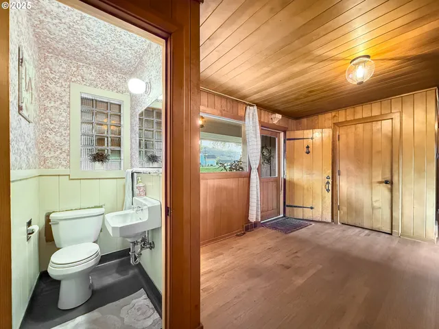 a bathroom with a toilet sink and a large mirror