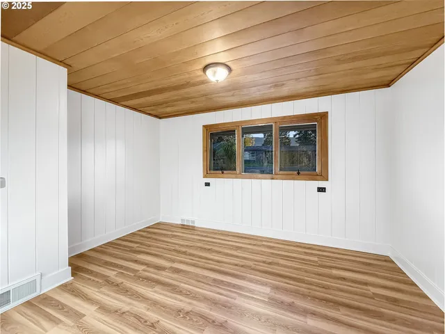 a view of a livingroom with wooden floor and large window