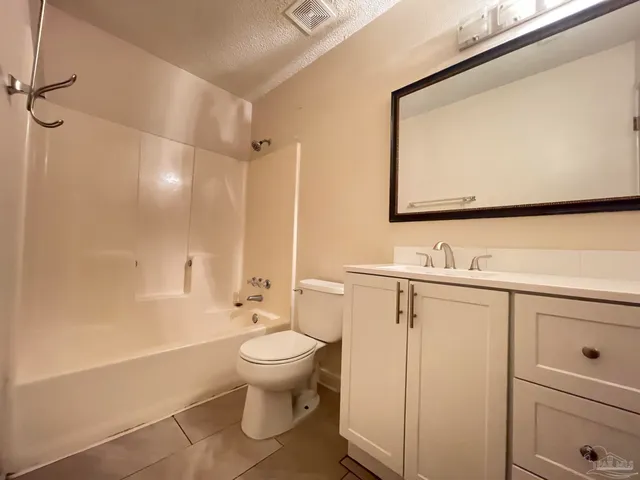 a kitchen with a stove a refrigerator and a microwave