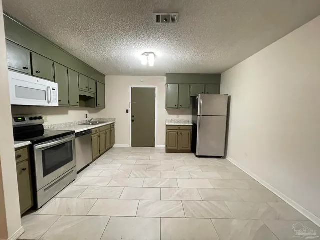 a view of a brick house with a bench