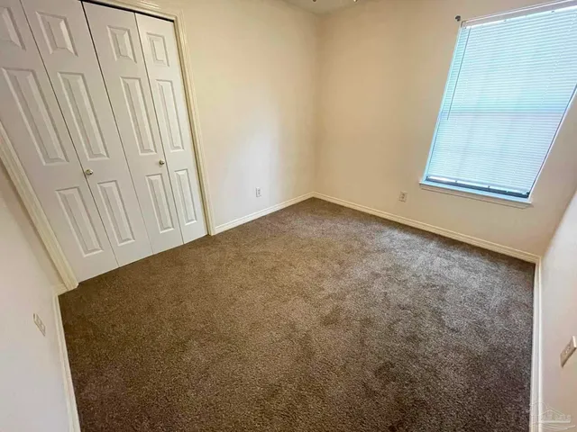 a backyard of a house with a large tree