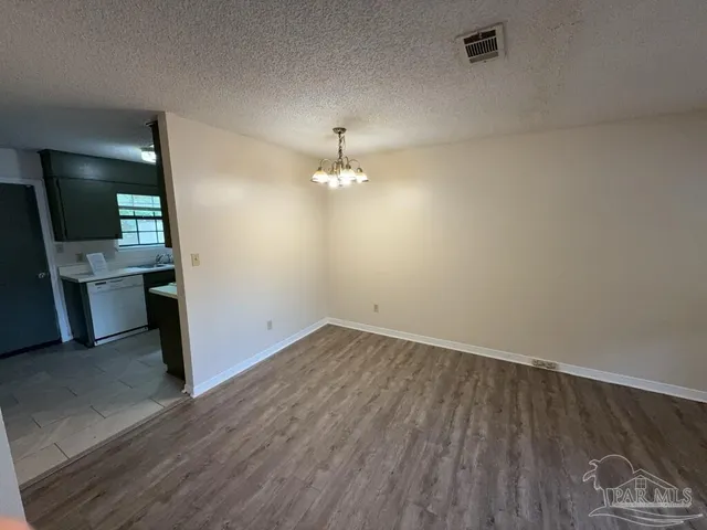 an empty room with wooden floor and closet