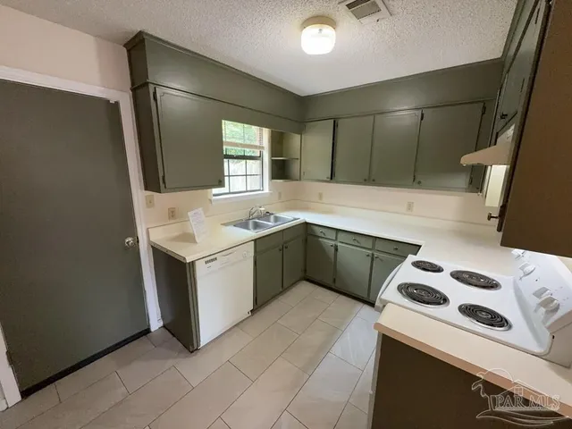 a white toilet sitting next to a bath tub