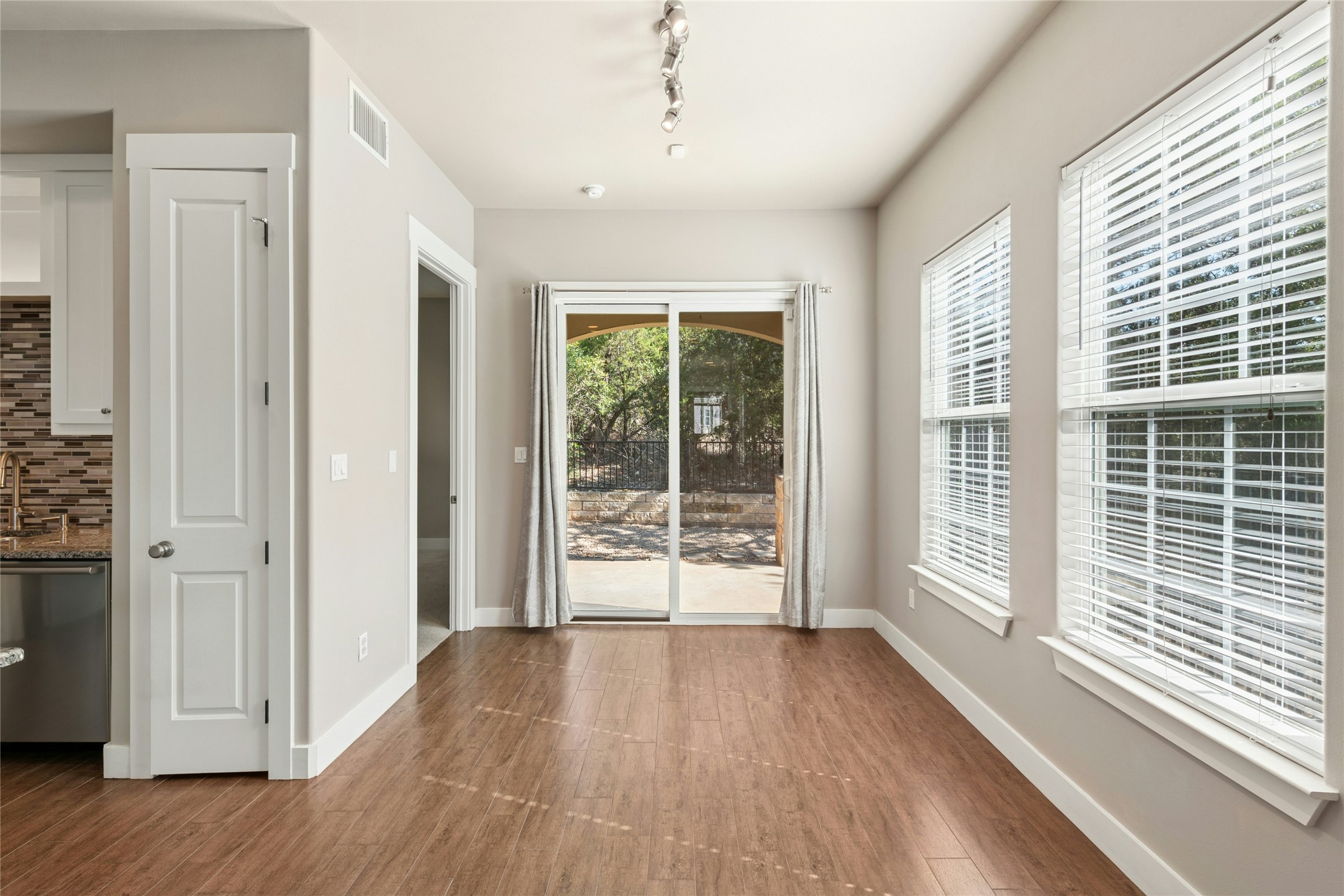 4301 Mansfield Dam Road, Unit 2101 Austin, TX 78734 - Photo 6 of 17 Unfurnished dining area featuring dark wood-style flooring and rail lighting
