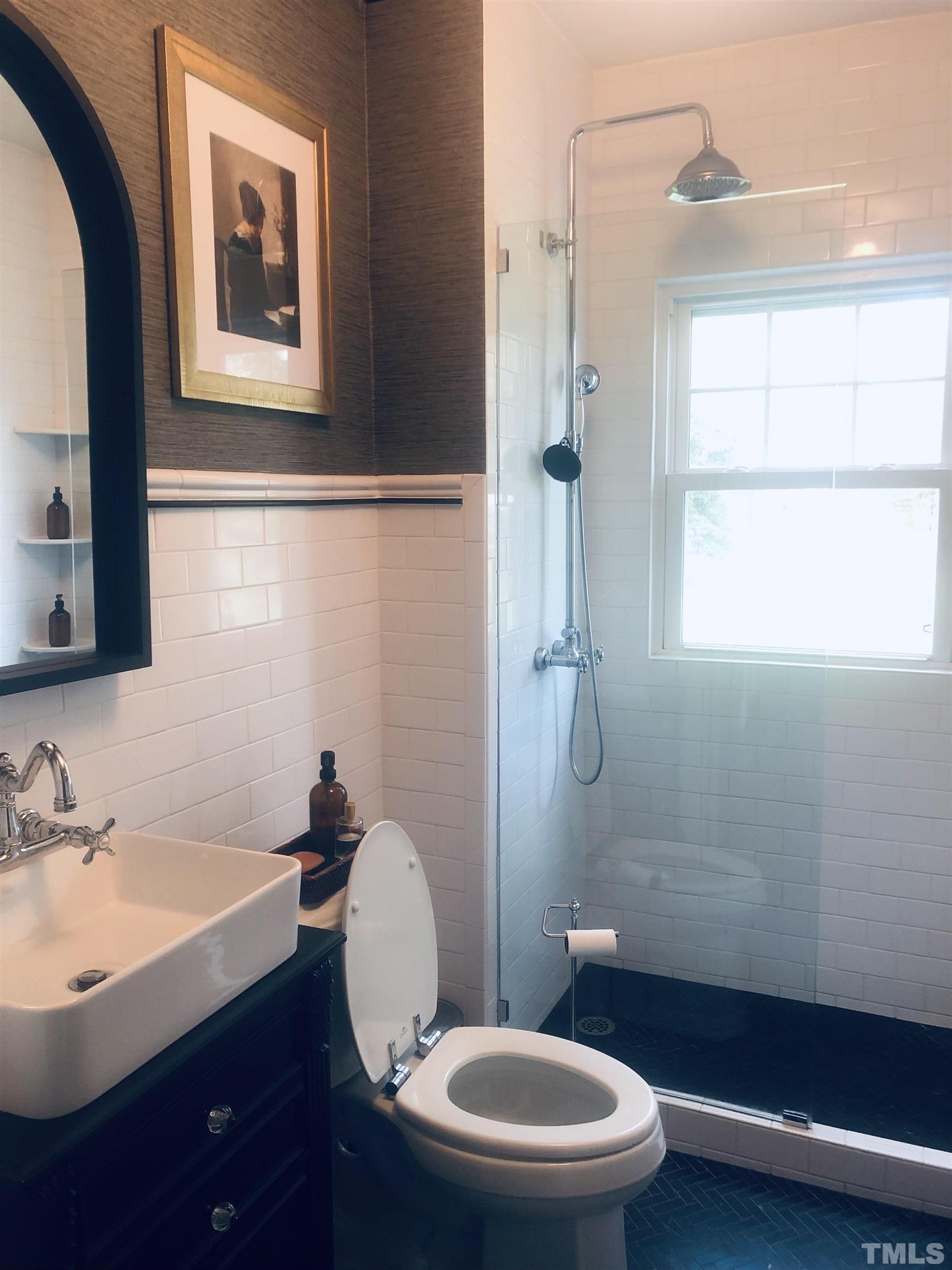 615 Milton Road Durham, NC 27712 - Photo 14 of 36 a bathroom with a sink a toilet a mirror and shower