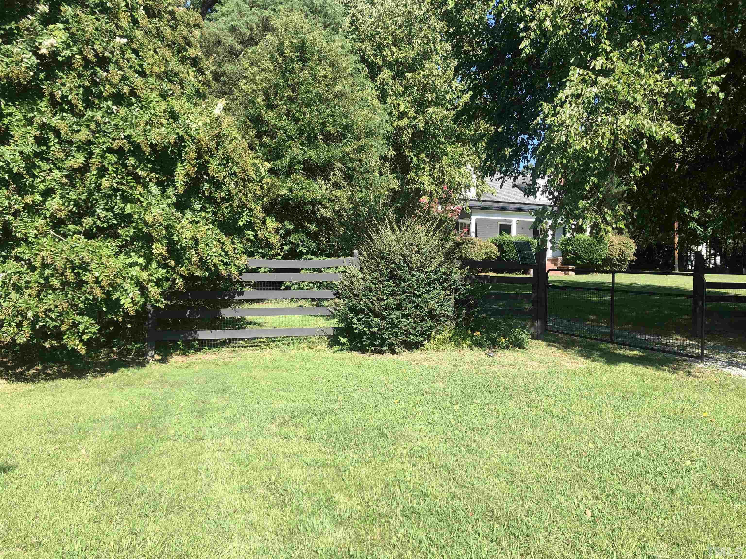 615 Milton Road Durham, NC 27712 - Photo 34 of 36 a view of backyard with table and chairs and potted plants and large trees