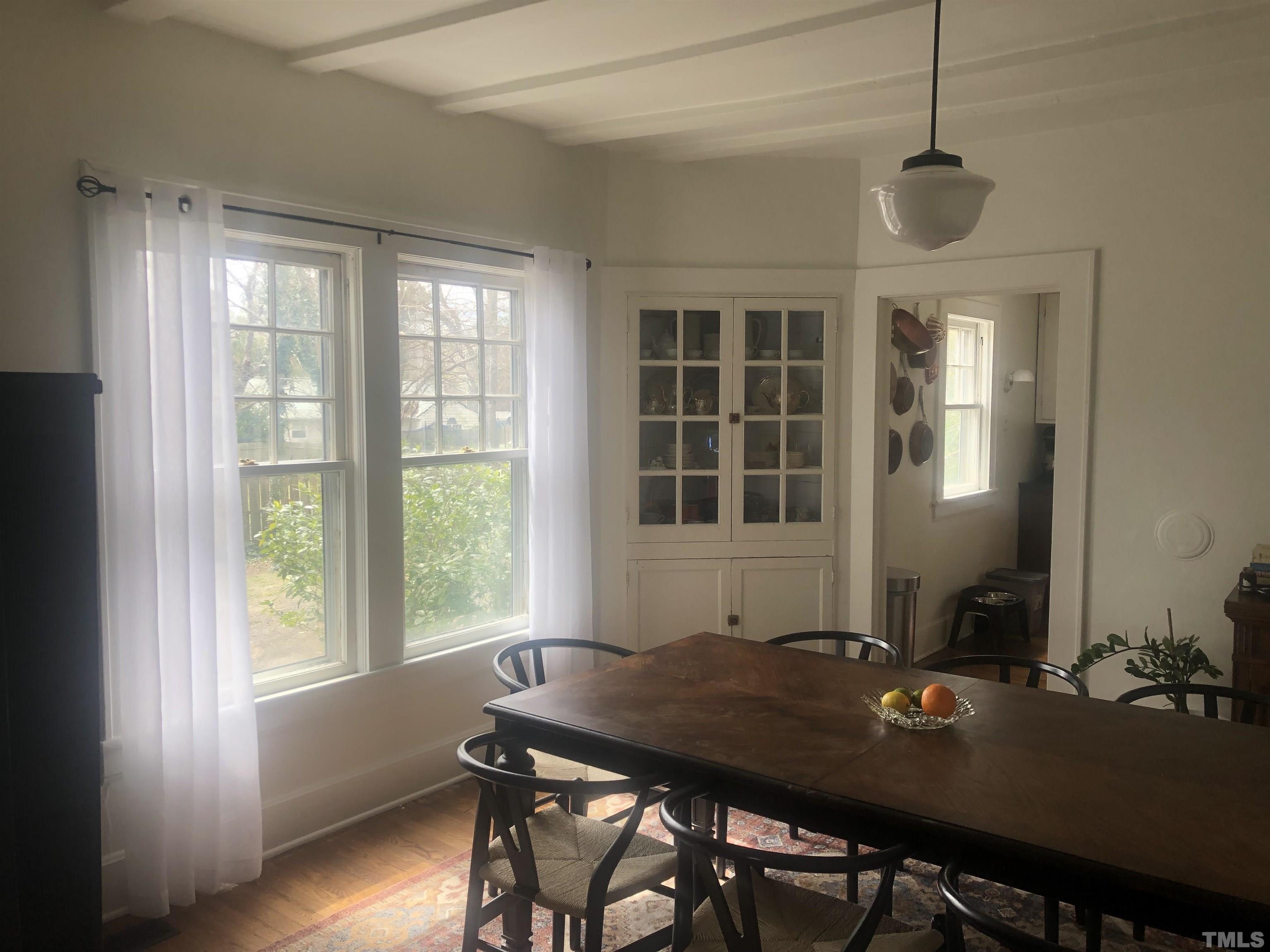 615 Milton Road Durham, NC 27712 - Photo 7 of 36 a view of a dining room with furniture window and wooden floor