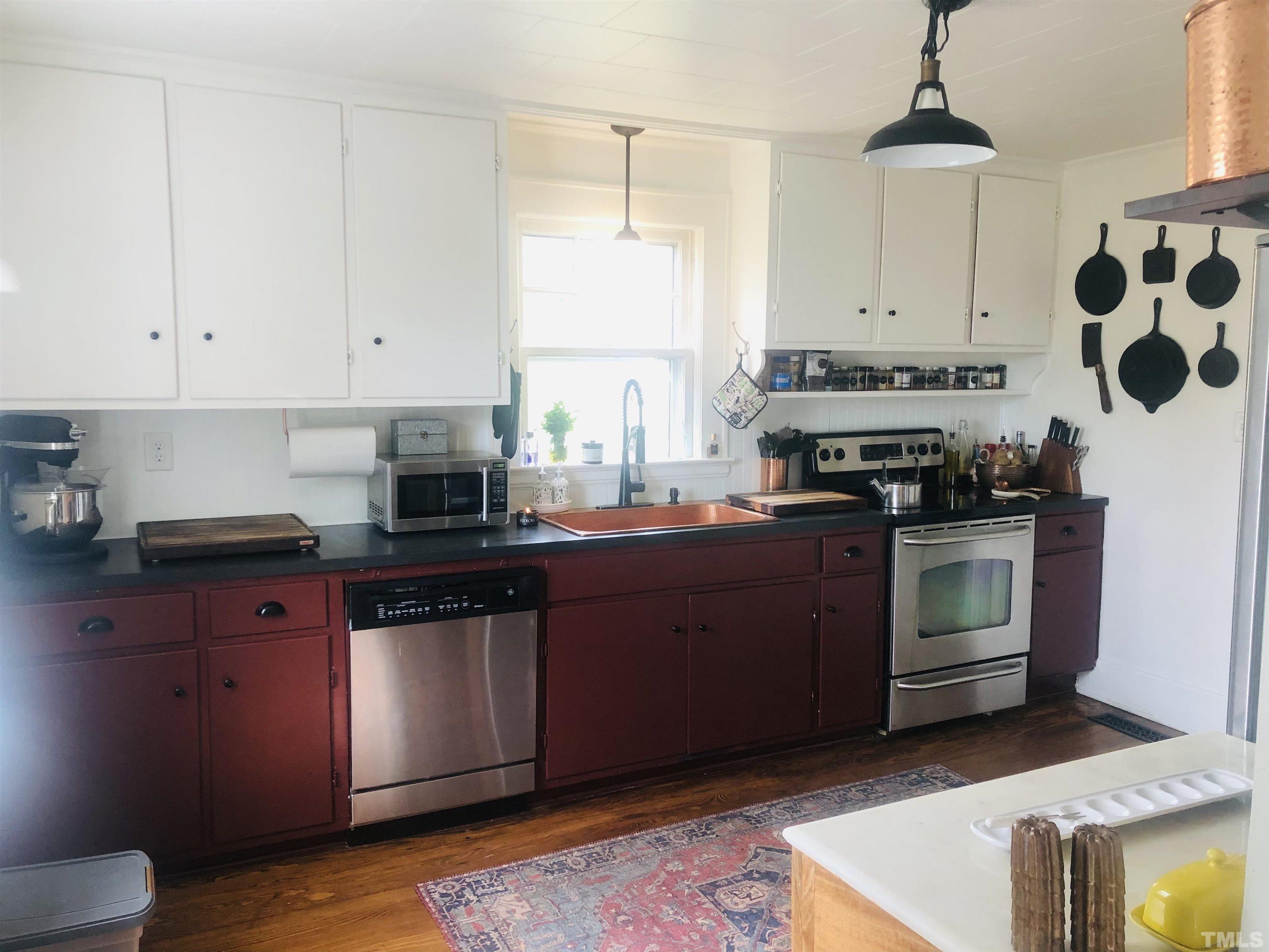 615 Milton Road Durham, NC 27712 - Photo 9 of 36 a kitchen with stainless steel appliances granite countertop a stove a sink and a microwave