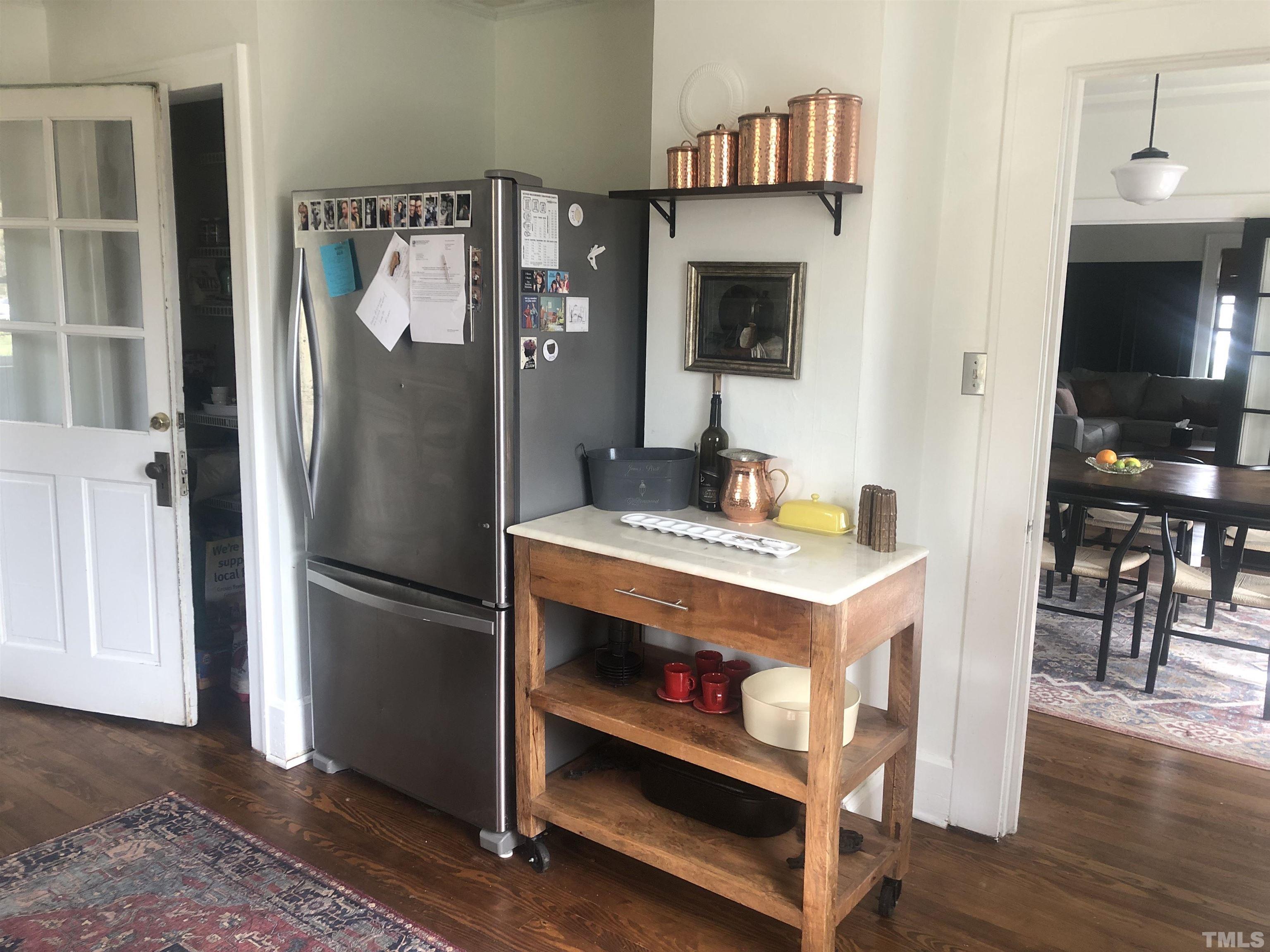 615 Milton Road Durham, NC 27712 - Photo 10 of 36 a kitchen with refrigerator and table