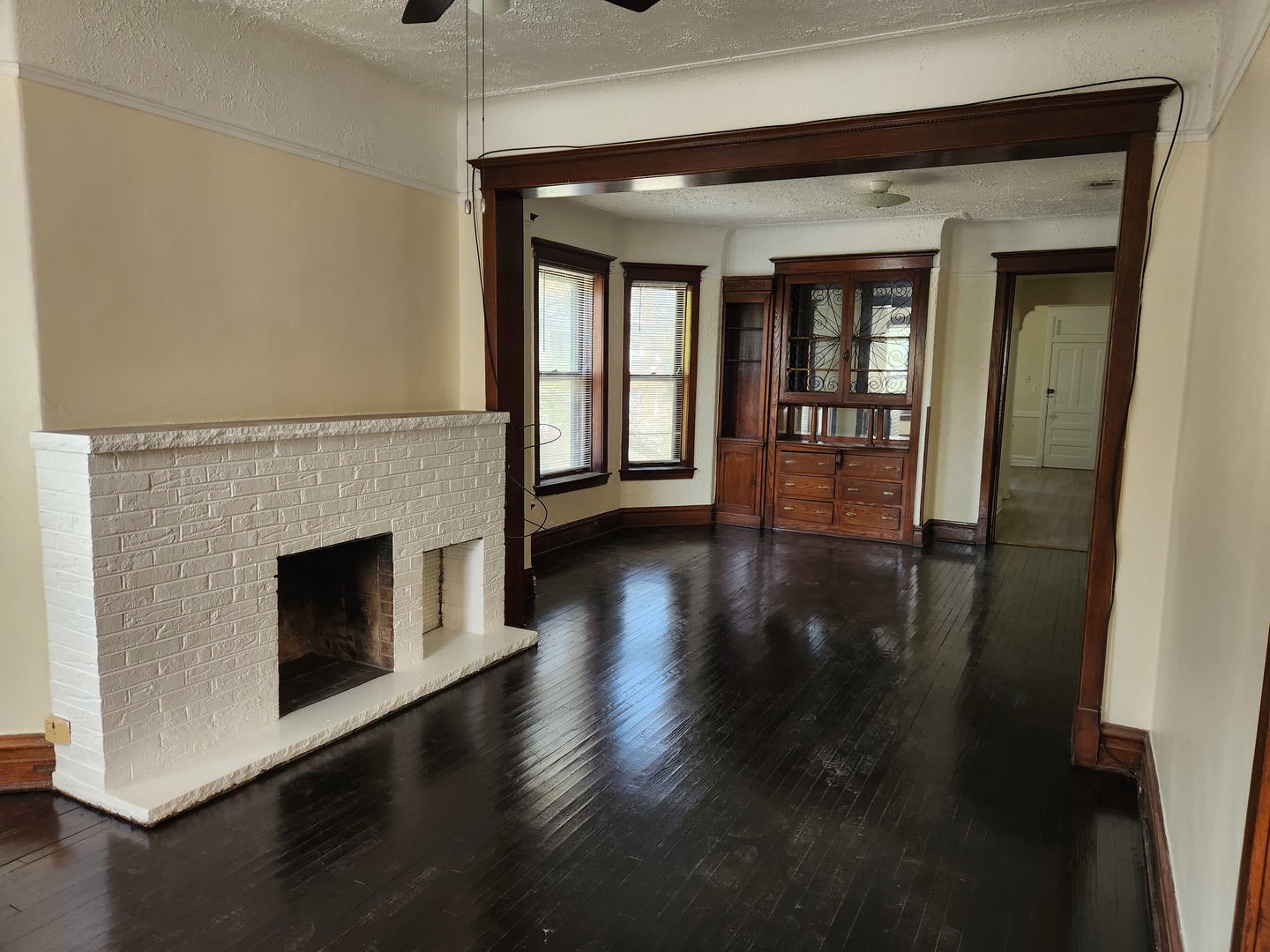 2224 West Irving Park Road, Unit 2 Chicago, IL 60618 - Photo 2 of 11 a view of an empty room with wooden floor and a window