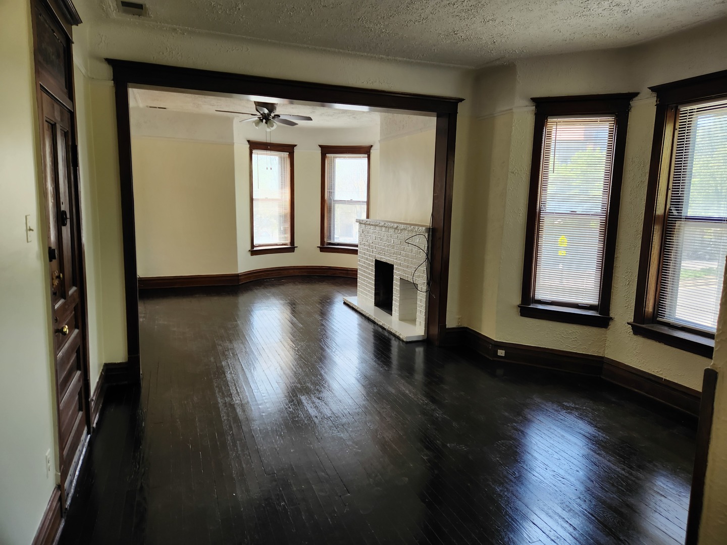 2224 West Irving Park Road, Unit 2 Chicago, IL 60618 - Photo 3 of 11 an empty room with wooden floor and windows