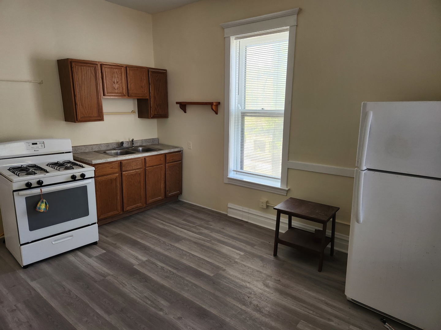 2224 West Irving Park Road, Unit 2 Chicago, IL 60618 - Photo 5 of 11 a kitchen with stainless steel appliances granite countertop a stove a sink and a refrigerator