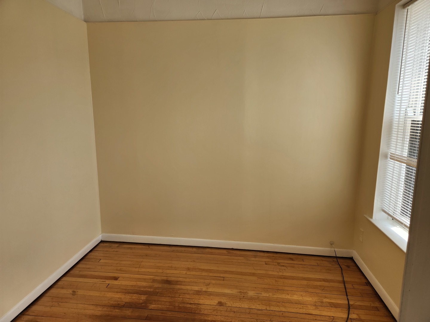 2224 West Irving Park Road, Unit 2 Chicago, IL 60618 - Photo 8 of 11 a view of a small space with wooden floor and a window