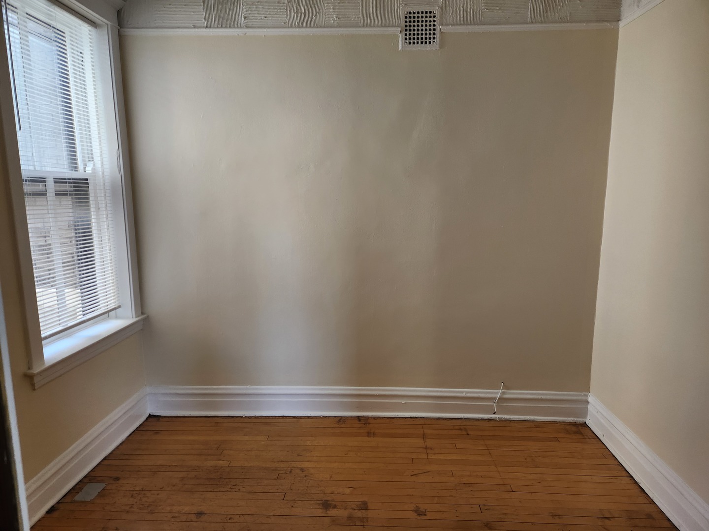 2224 West Irving Park Road, Unit 2 Chicago, IL 60618 - Photo 9 of 11 a view of an empty room with wooden floor and a window