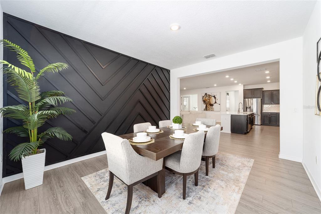 7233 Southwest 64th St Road Ocala, FL 34474 - Photo 14 of 48 a dining room with furniture potted plants and wooden floor