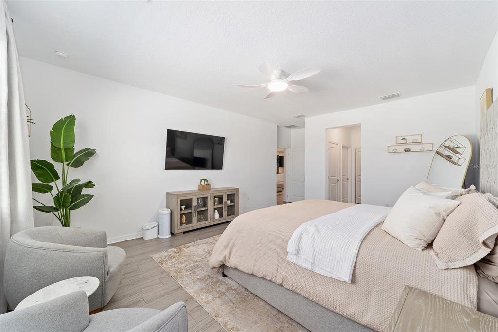 7233 Southwest 64th St Road Ocala, FL 34474 - Photo 18 of 48 a bedroom with a large bed and a flat screen tv