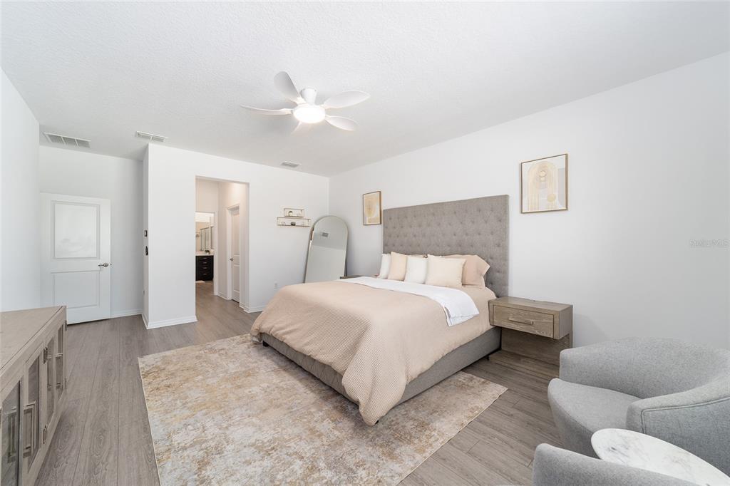 7233 Southwest 64th St Road Ocala, FL 34474 - Photo 19 of 48 a bedroom with a bed and a chandelier