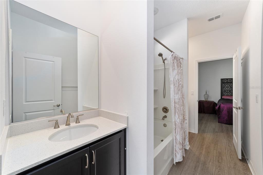7233 Southwest 64th St Road Ocala, FL 34474 - Photo 26 of 48 a en suite bathroom with a double vanity sink a mirror and a shower