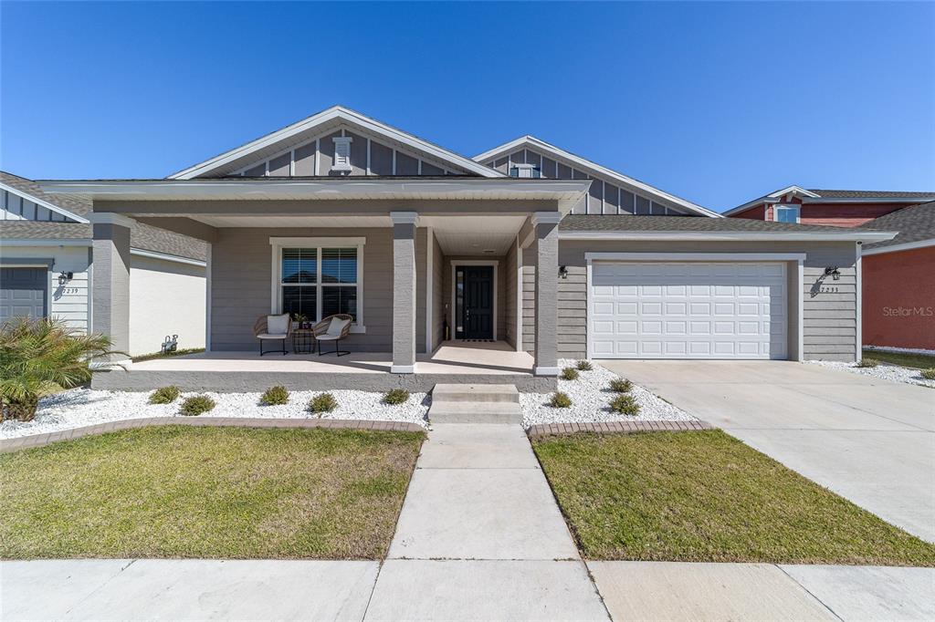 7233 Southwest 64th St Road Ocala, FL 34474 - Photo 3 of 48 a front view of a house with garden