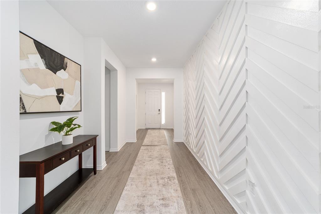 7233 Southwest 64th St Road Ocala, FL 34474 - Photo 5 of 48 a hallway with a dining table and chairs