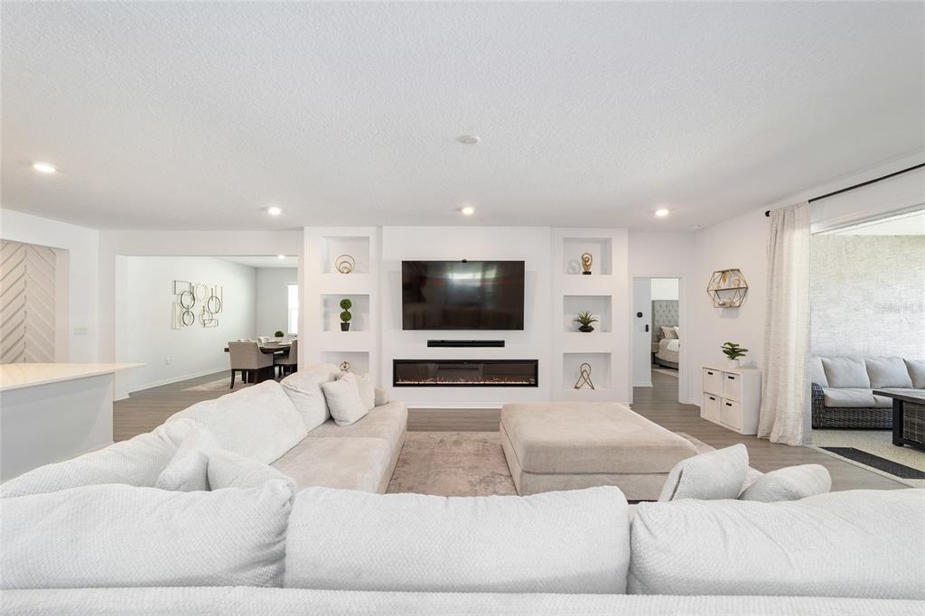 7233 Southwest 64th St Road Ocala, FL 34474 - Photo 8 of 48 a living room with furniture and a flat screen tv
